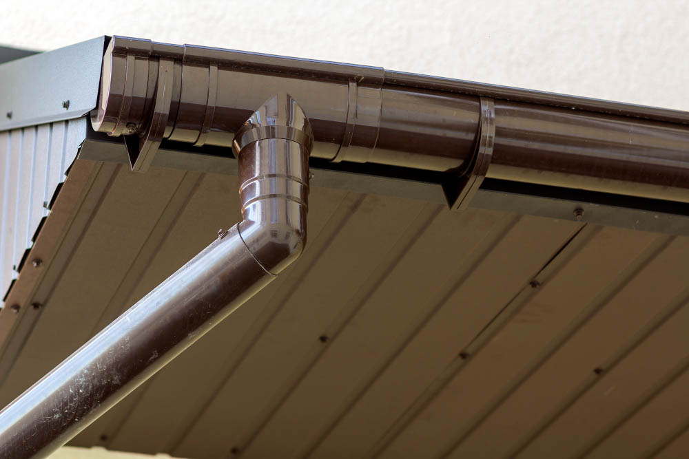 gutter-services-2 Builder Working On Roof Of New Building, Construction Worker Wea